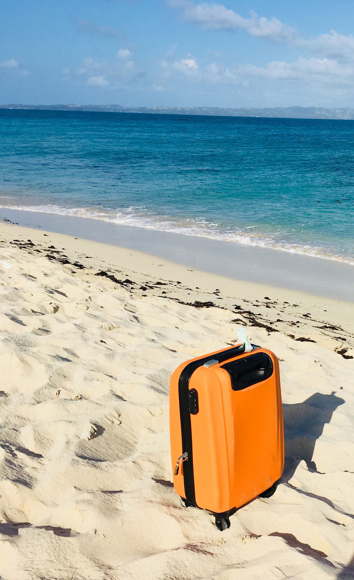 travel--Suitcase-on-Beach