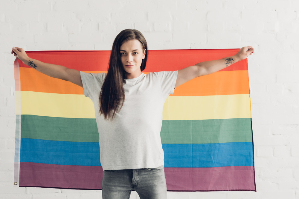 Karen - Hot Talk in the City - confident-transgender-woman-holding-pride-flag-in-2021